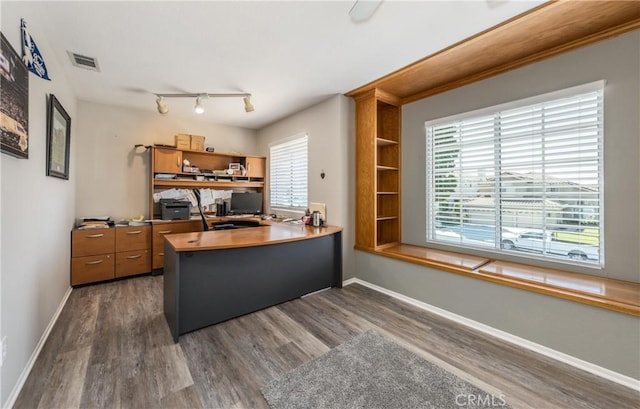28852 Glenheather Dr, Highland, CA 92346 - home office with dark wood-style floors, baseboards, and rail lighting