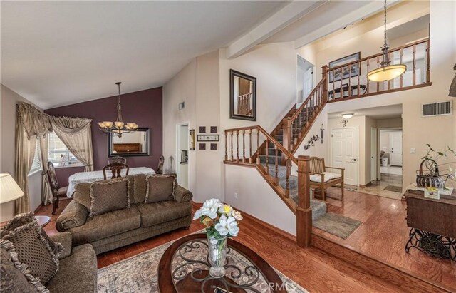 28852 Glenheather Dr, Highland, CA 92346 - living room featuring a chandelier, wood finished floors, stairs, and high vaulted ceiling