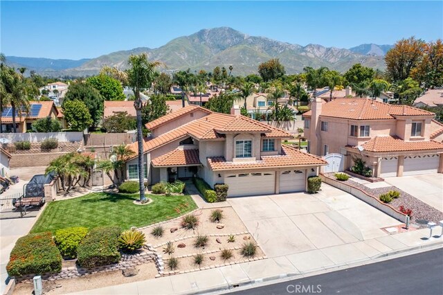 28852 Glenheather Dr, Highland, CA 92346 - mediterranean / spanish-style home featuring stucco siding, a tiled roof, concrete driveway, a residential view, and a mountain view