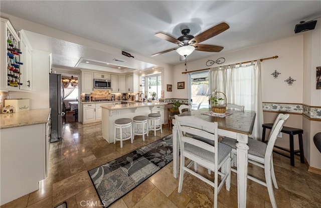 28852 Glenheather Dr, Highland, CA 92346 - dining area with a ceiling fan and a raised ceiling