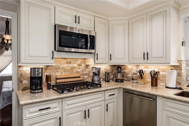 28852 Glenheather Dr, Highland, CA 92346 - kitchen featuring stainless steel appliances, tasteful backsplash, and white cabinetry