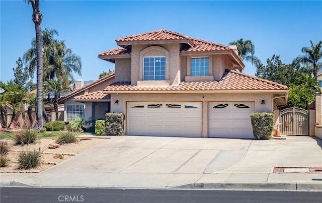28852 Glenheather Dr, Highland, CA 92346 - mediterranean / spanish-style house featuring stucco siding, driveway, a gate, and a tile roof