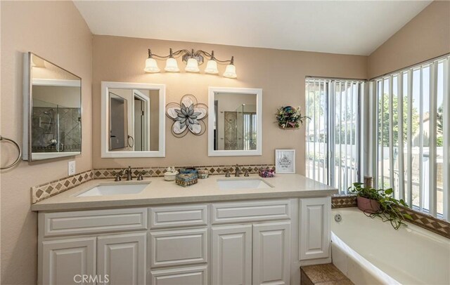 28852 Glenheather Dr, Highland, CA 92346 - bathroom featuring plenty of natural light, double vanity, a garden tub, and lofted ceiling