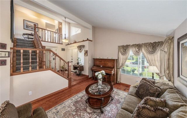 28852 Glenheather Dr, Highland, CA 92346 - living room featuring vaulted ceiling, healthy amount of natural light, stairway, wood finished floors, and baseboards