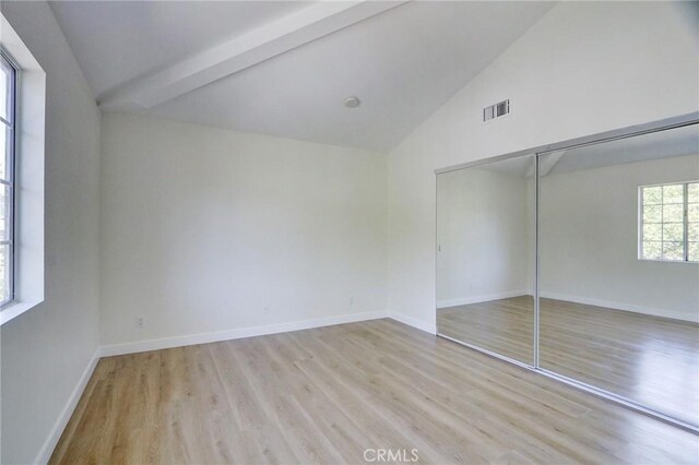3236 Honolulu Ave Unit 101, La Crescenta, CA 91214 - unfurnished bedroom with wood finished floors, beam ceiling, a closet, baseboards, and high vaulted ceiling