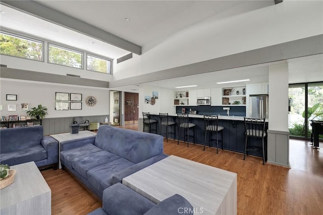 3602 W Estates Ln Unit 306, Rolling Hills Estates, CA 90274 - living area featuring wood finished floors, beamed ceiling, and a high ceiling