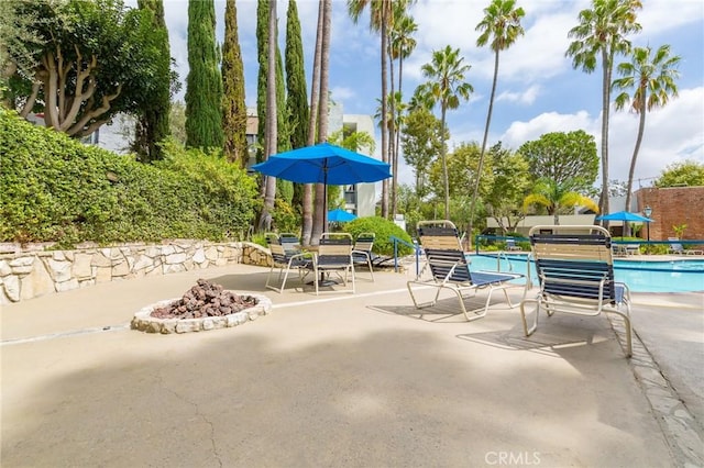 3602 W Estates Ln Unit 306, Rolling Hills Estates, CA 90274 - view of patio with a fire pit and a community pool