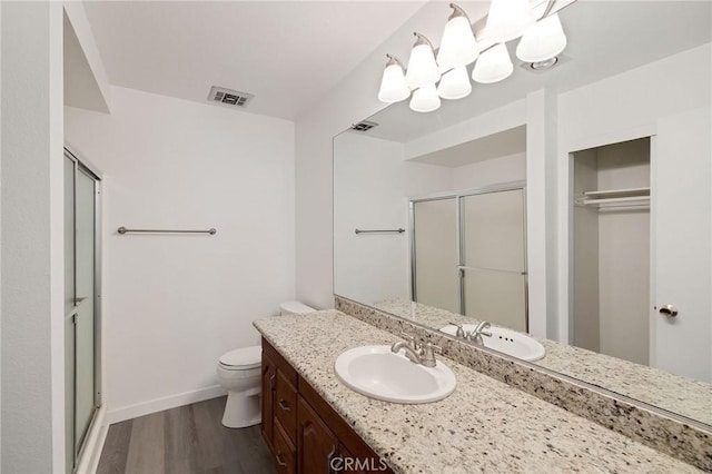 3602 W Estates Ln Unit 306, Rolling Hills Estates, CA 90274 - bathroom with wood finished floors, a shower stall, vanity, baseboards, and toilet