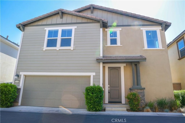 13936 Blossom Way, Eastvale, CA 92880 - view of front of house with an attached garage, board and batten siding, and driveway