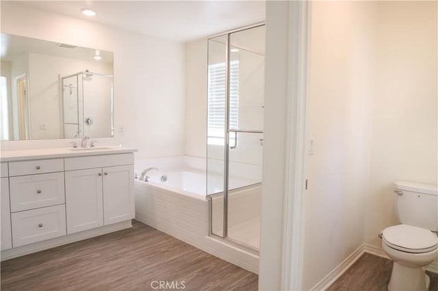 13936 Blossom Way, Eastvale, CA 92880 - bathroom featuring vanity, a bath, a shower stall, toilet, and wood finished floors