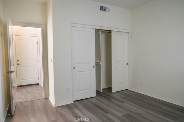 13936 Blossom Way, Eastvale, CA 92880 - unfurnished bedroom with wood finished floors, baseboards, and a closet