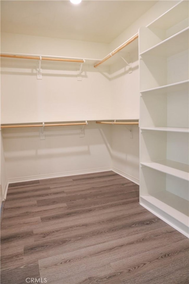 13936 Blossom Way, Eastvale, CA 92880 - walk in closet featuring dark wood-type flooring