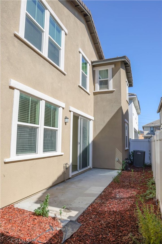 13936 Blossom Way, Eastvale, CA 92880 - back of property featuring stucco siding, a patio, and cooling unit