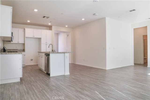 13936 Blossom Way, Eastvale, CA 92880 - kitchen with white cabinetry, light wood-type flooring, recessed lighting, an island with sink, and baseboards