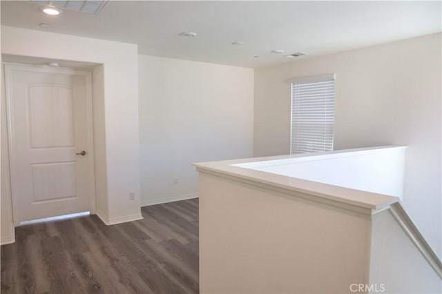 13936 Blossom Way, Eastvale, CA 92880 - corridor featuring dark wood finished floors, baseboards, recessed lighting, and an upstairs landing
