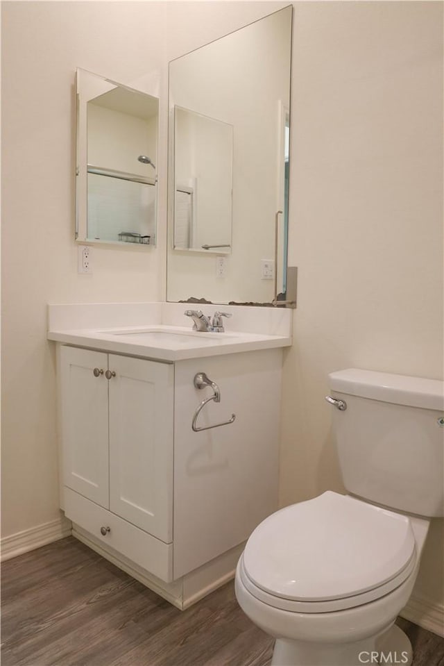 13936 Blossom Way, Eastvale, CA 92880 - bathroom with wood finished floors, toilet, baseboards, and vanity