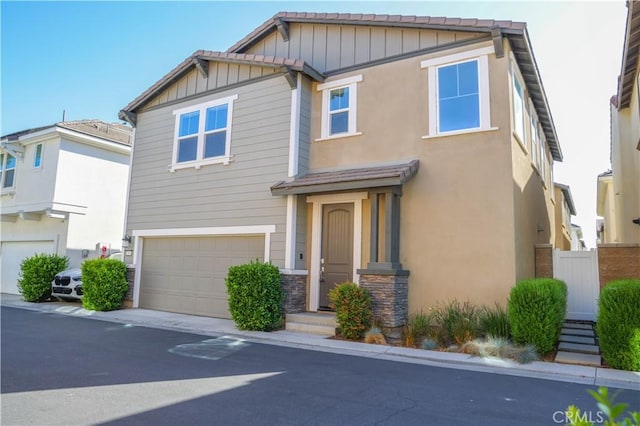 13936 Blossom Way, Eastvale, CA 92880 - craftsman house featuring board and batten siding, an attached garage, and stone siding