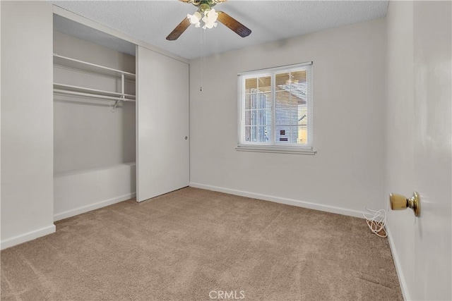 560 E Mountain View St, Barstow, CA 92311 - unfurnished bedroom featuring carpet floors, baseboards, a closet, and a ceiling fan