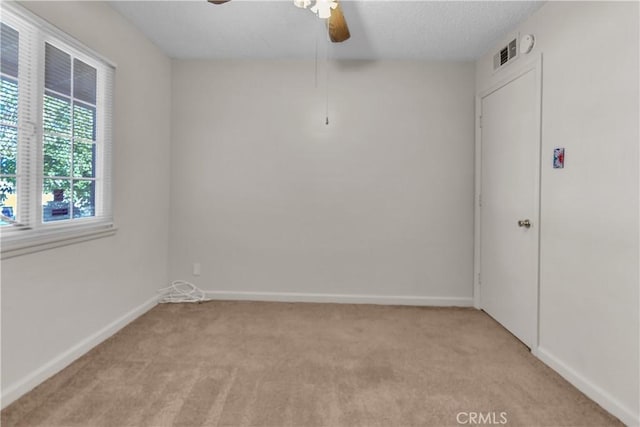 560 E Mountain View St, Barstow, CA 92311 - spare room with light carpet, a ceiling fan, baseboards, and a textured ceiling