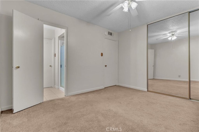560 E Mountain View St, Barstow, CA 92311 - unfurnished bedroom featuring carpet, a textured ceiling, a ceiling fan, a closet, and baseboards