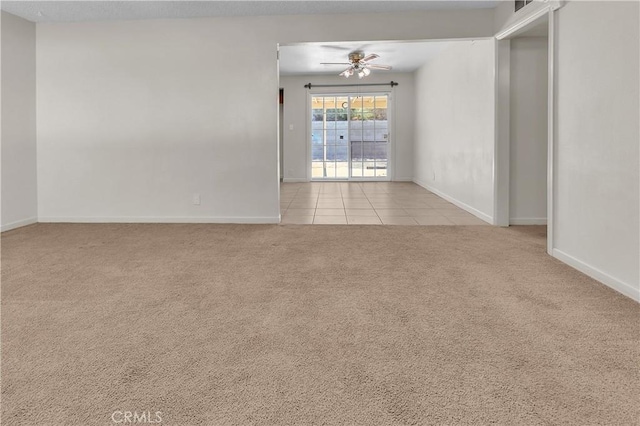 560 E Mountain View St, Barstow, CA 92311 - spare room with carpet floors, a ceiling fan, baseboards, and tile patterned floors