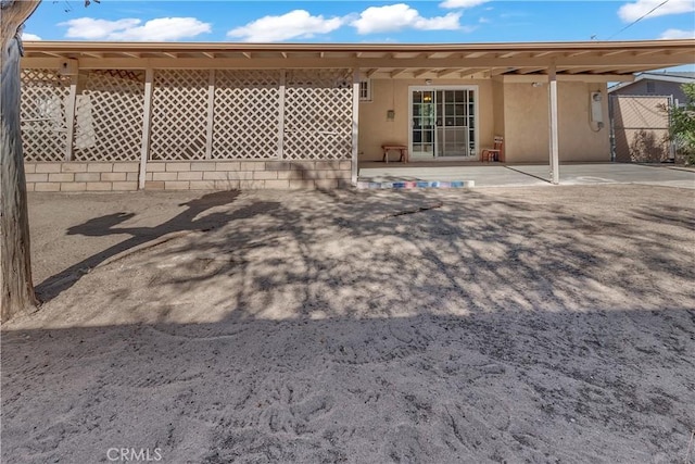 560 E Mountain View St, Barstow, CA 92311 - rear view of property with stucco siding and a patio