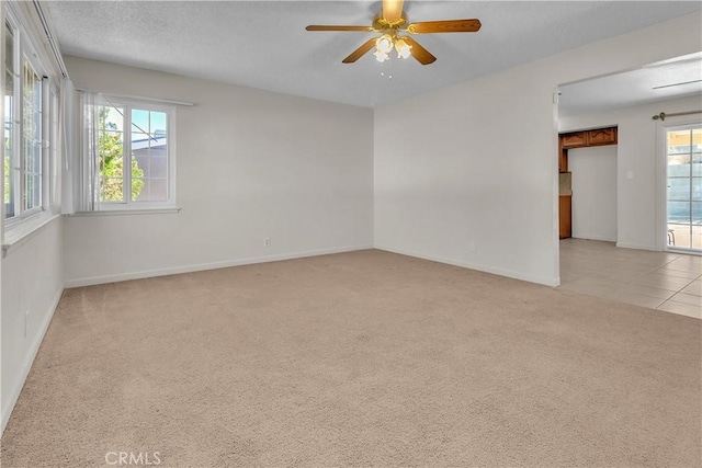 560 E Mountain View St, Barstow, CA 92311 - spare room featuring light carpet, baseboards, and ceiling fan