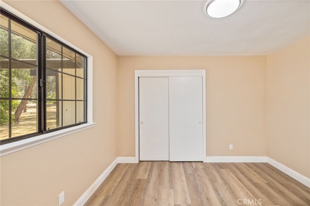 42490 Ranger Circle Way, Coarsegold, CA 93614 - unfurnished bedroom with light wood finished floors, baseboards, and a closet