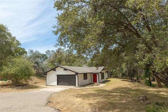 42490 Ranger Circle Way, Coarsegold, CA 93614 - view of front of property featuring asphalt driveway, an attached garage, view of scattered trees, and a front yard