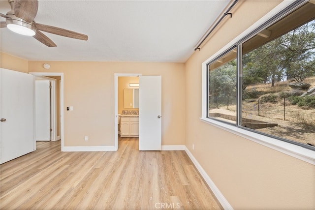42490 Ranger Circle Way, Coarsegold, CA 93614 - unfurnished bedroom with light wood-style flooring, baseboards, ensuite bath, and ceiling fan