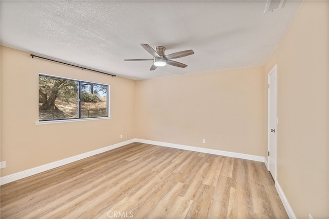 42490 Ranger Circle Way, Coarsegold, CA 93614 - spare room featuring light wood-type flooring, ceiling fan, baseboards, and a textured ceiling