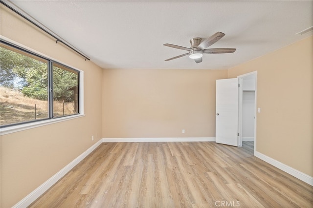 42490 Ranger Circle Way, Coarsegold, CA 93614 - unfurnished room with light wood finished floors, baseboards, and a ceiling fan