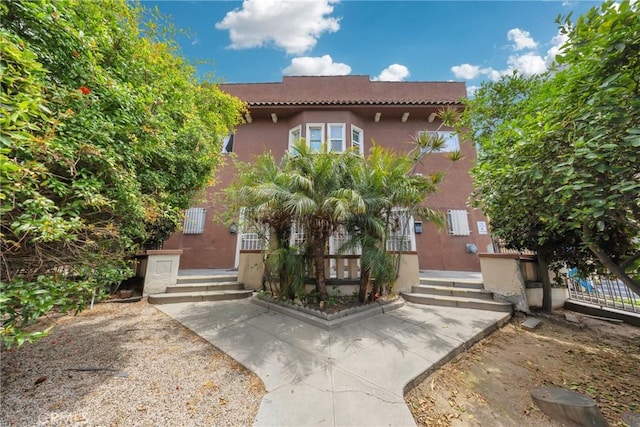 2006 S Harcourt Ave, Los Angeles, CA 90016 - mediterranean / spanish-style house featuring stucco siding and a tile roof