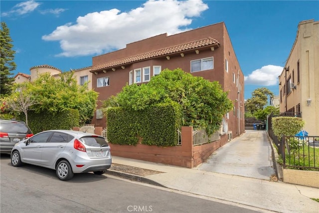 2006 S Harcourt Ave, Los Angeles, CA 90016 - view of front of property with a tiled roof and stucco siding