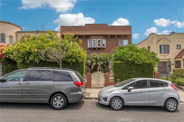2006 S Harcourt Ave, Los Angeles, CA 90016 - view of front of home with a tiled roof and stucco siding