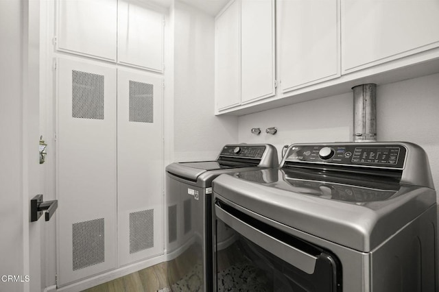 2328 N H St, Oxnard, CA 93036 - laundry room with washing machine and clothes dryer, cabinet space, a heating unit, and wood finished floors