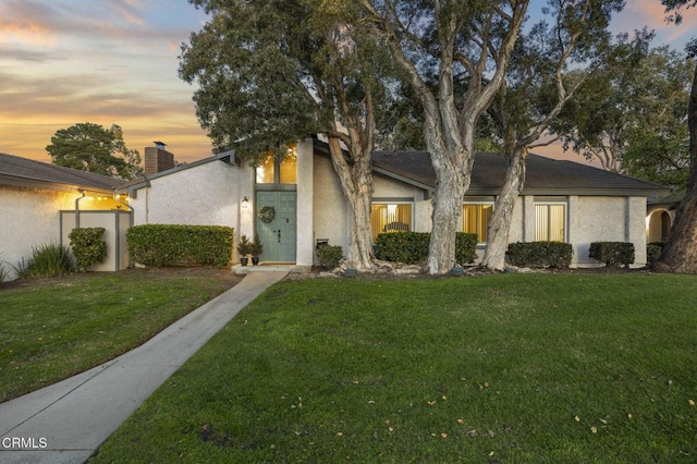 2328 N H St, Oxnard, CA 93036 - mid-century home with a chimney, a lawn, and stucco siding