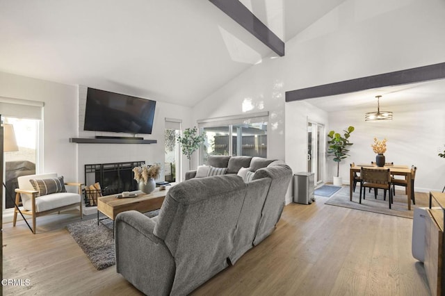 2328 N H St, Oxnard, CA 93036 - living area featuring high vaulted ceiling, light wood-type flooring, a large fireplace, beam ceiling, and baseboards