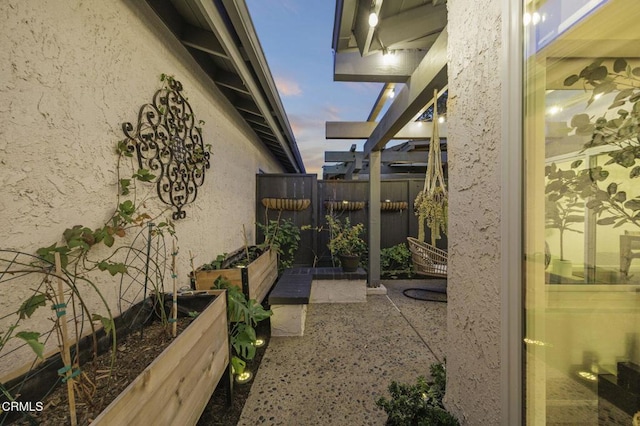 2328 N H St, Oxnard, CA 93036 - view of side of property with stucco siding, a vegetable garden, and a patio