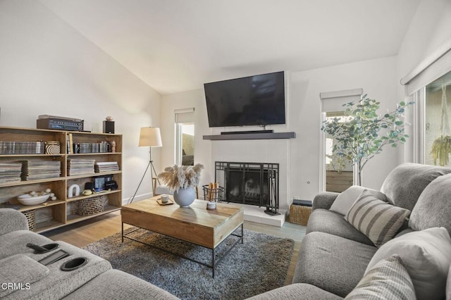 2328 N H St, Oxnard, CA 93036 - living area with a fireplace, wood finished floors, and lofted ceiling