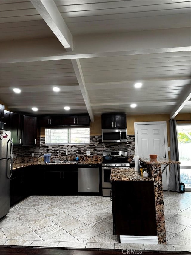 12968 Vaughn St, San Fernando, CA 91340 - kitchen featuring stainless steel appliances, a sink, tasteful backsplash, dark stone countertops, and recessed lighting