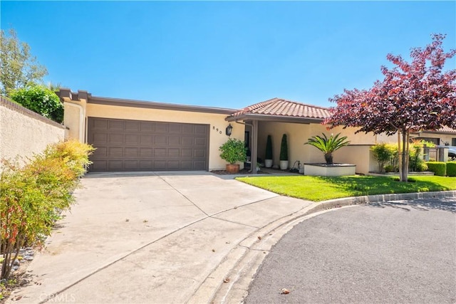 890 El Mirador, Upland, CA 91784 - view of front of house with stucco siding, a garage, driveway, and a tiled roof
