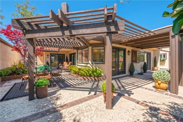 890 El Mirador, Upland, CA 91784 - rear view of house featuring a pergola, stucco siding, and a patio area