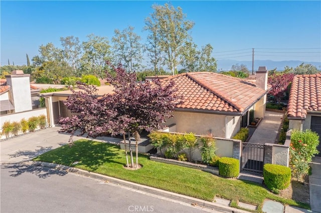 890 El Mirador, Upland, CA 91784 - mediterranean / spanish-style home featuring a tiled roof, stucco siding, a gate, and concrete driveway