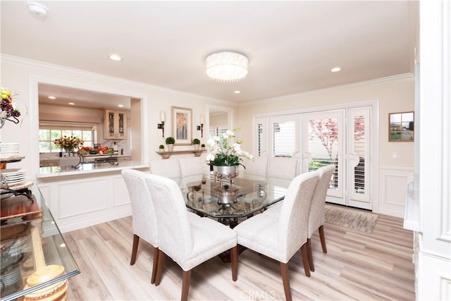 890 El Mirador, Upland, CA 91784 - dining room featuring a decorative wall, light wood-type flooring, ornamental molding, french doors, and wainscoting