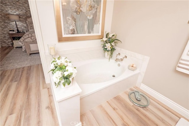 890 El Mirador, Upland, CA 91784 - bathroom featuring a garden tub and wood finished floors
