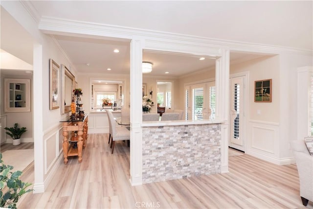 890 El Mirador, Upland, CA 91784 - kitchen featuring a decorative wall, plenty of natural light, light wood-type flooring, ornamental molding, and a wainscoted wall