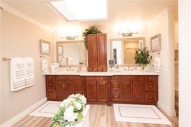 890 El Mirador, Upland, CA 91784 - bathroom featuring double vanity, wood finished floors, ornamental molding, and baseboards