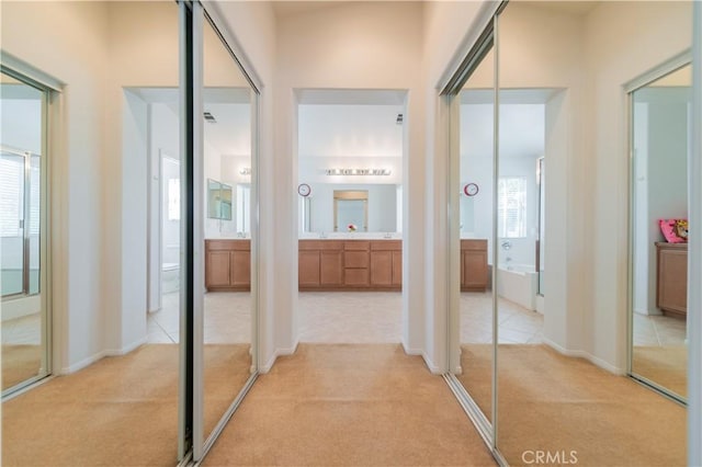 15752 Mimosa Ct, Fontana, CA 92336 - corridor featuring light colored carpet, plenty of natural light, and baseboards