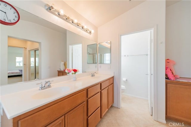 15752 Mimosa Ct, Fontana, CA 92336 - bathroom featuring double vanity, toilet, tile patterned floors, and vaulted ceiling